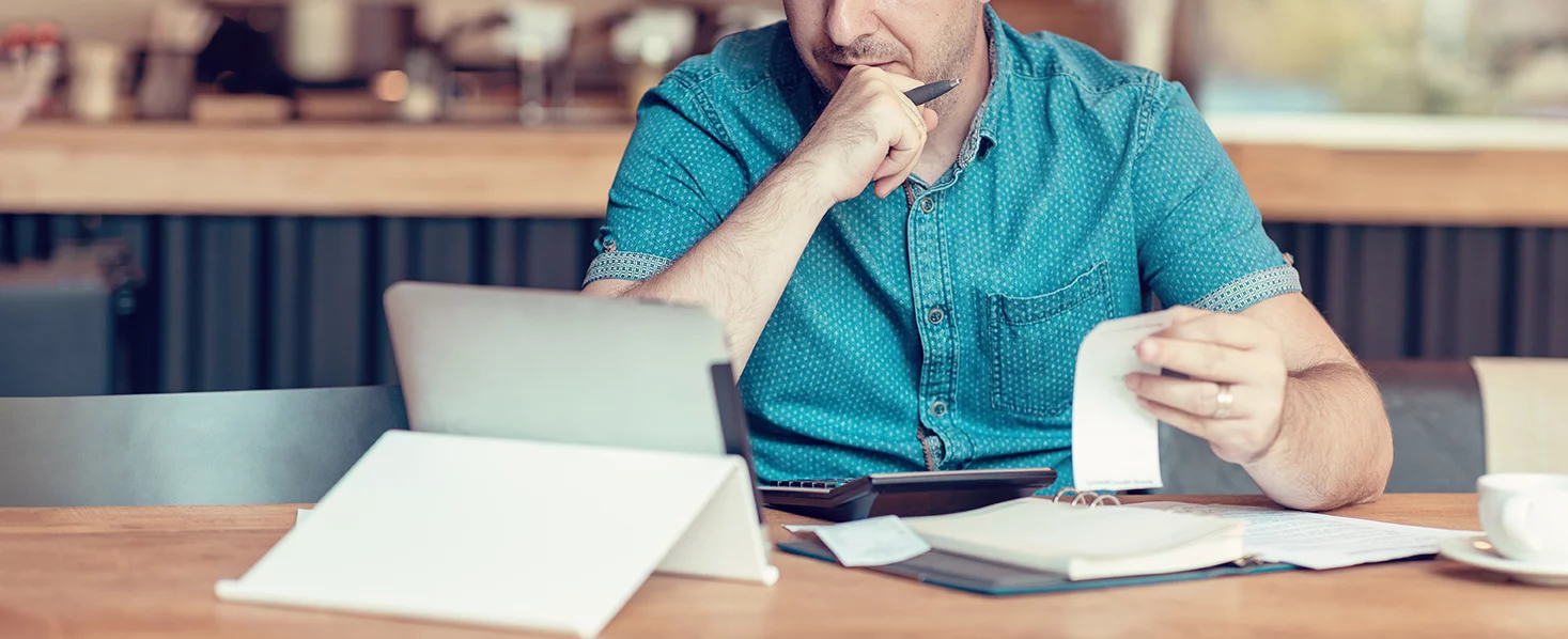 Person balancing accounts on tablet computer