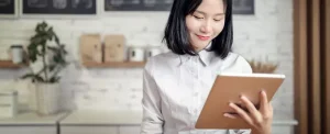 young smiling woman working on a tablet