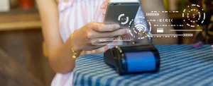 female hand holds phone above card reader with white graphic overlays