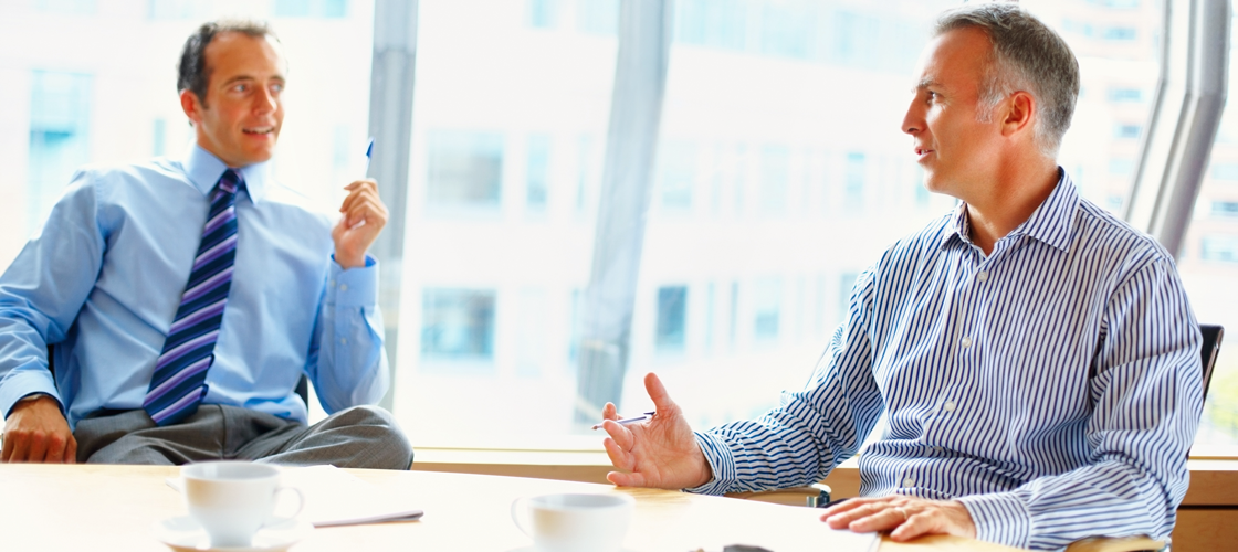 Men speaking to each other in a meeting