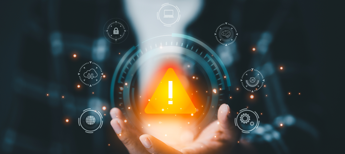 Holographic warning sign above an open hand